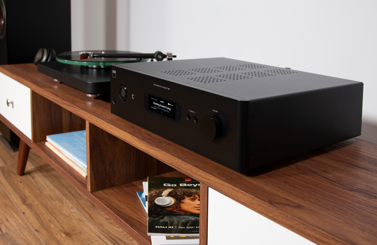 NAD C399 amplifier on a table|NAD C 399 Front with BluOS display|C399 Amplifier in an entertainment setup|Rear shot of a C 399 Amplifier|Rear shot of a C 399 Amplifier